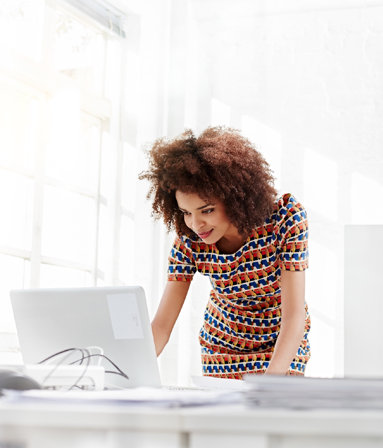 Woman works on her laptop computer in the office.