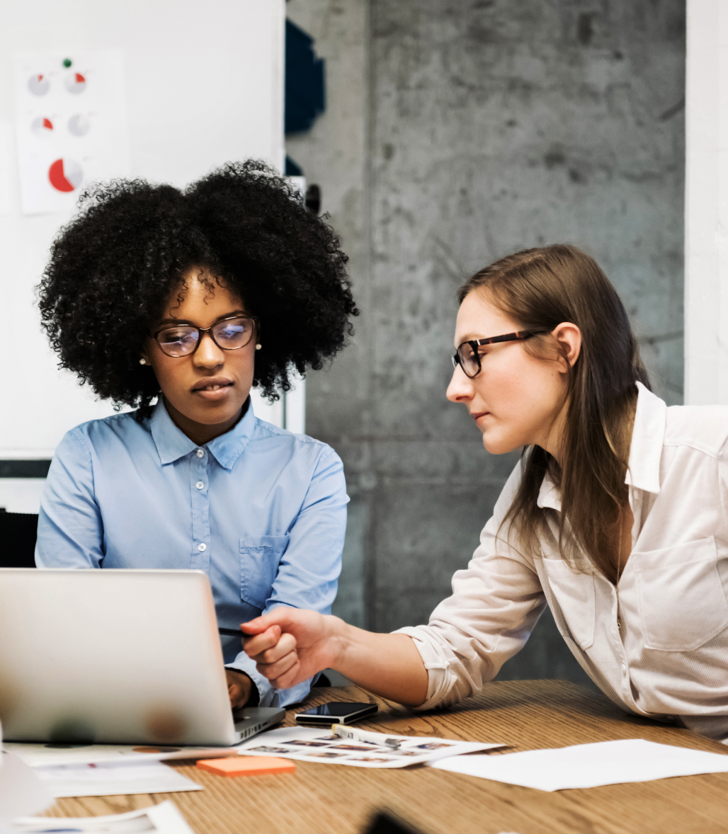 Two women at a desk in discussion